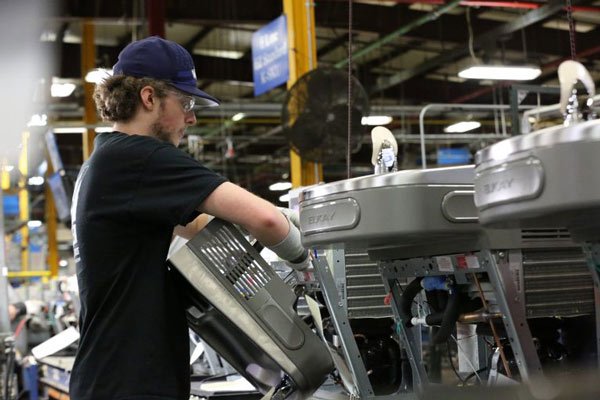 workers manufacturing water fountains in factory